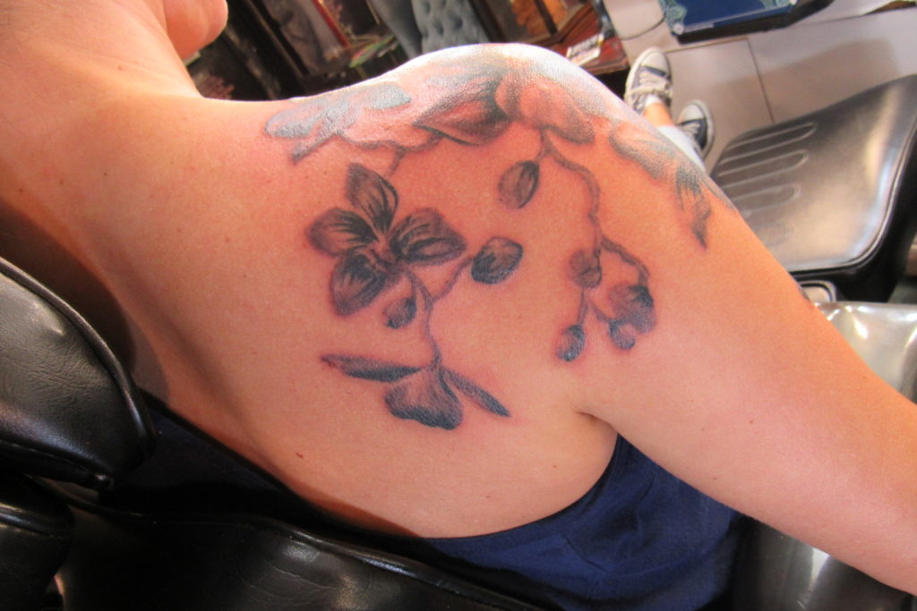 Greyscale orchids on shoulder